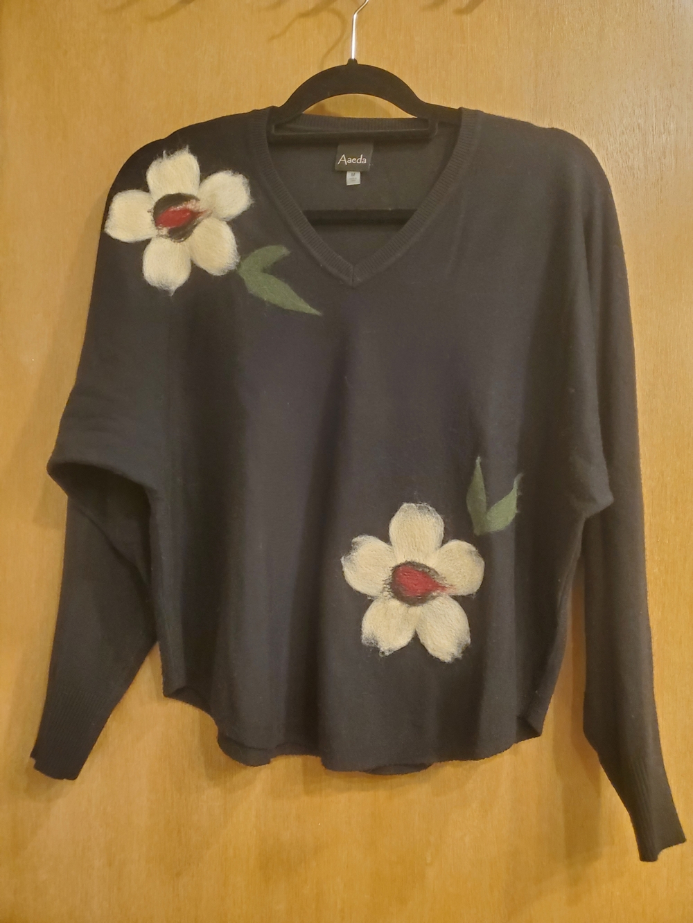 Aaeda Black V-Neck Sweater with Cream Floral Appliqués